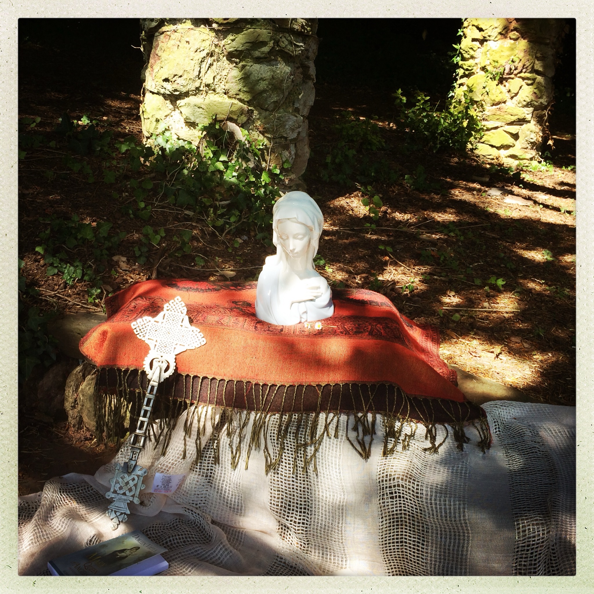 The Virgin Mary and a crucifix catch the sun rays